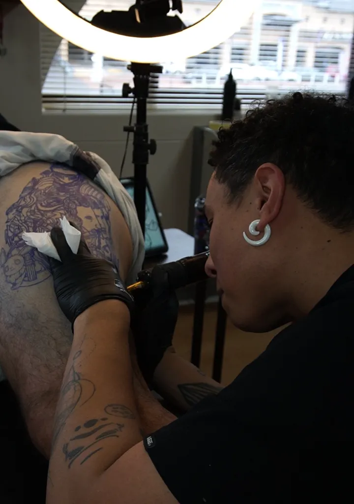 Kyle tattooing shoulder - Aerial photo